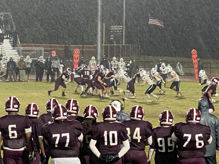 SV Varsity Football playing through rain. 